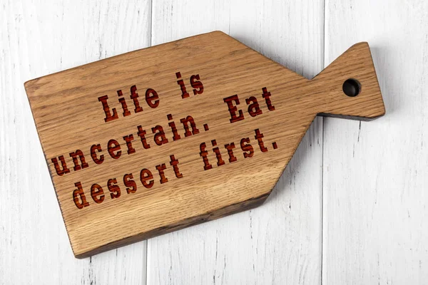 Wooden cutting board with wise inscription about food — Stock Photo, Image