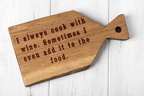 Wooden cutting board with wise inscription about food — 스톡 사진