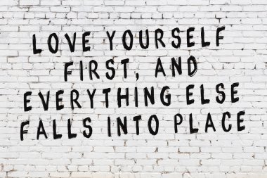 Boyalı siyah motivasyonel alıntı yazıtı ile beyaz tuğla duvar