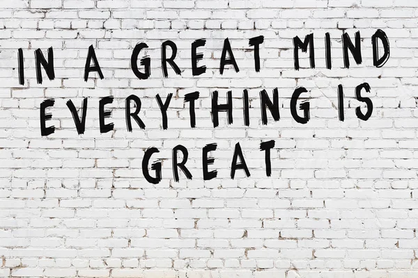 White brick wall with painted black motivational quote inscription — Stock Photo, Image