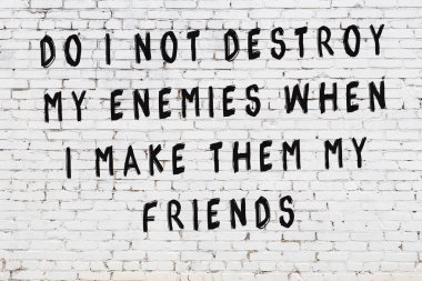 Beyaz tuğla duvar arkaplanına siyah düşünceli bir yazı.