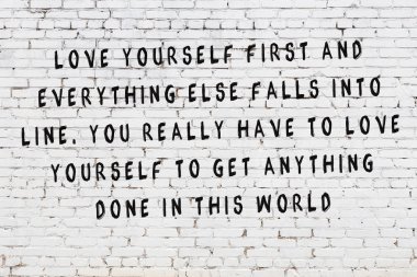 Beyaz tuğla duvara boyalı siyah yazıt