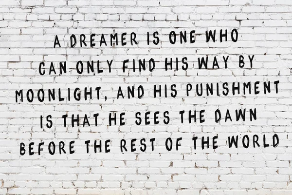 Painted black inscription on white brick wall — Stock Photo, Image