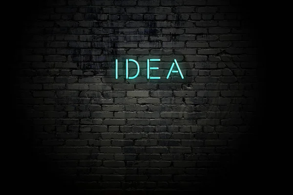 Gemarkeerde bakstenen muur met neon inscriptie idee — Stockfoto