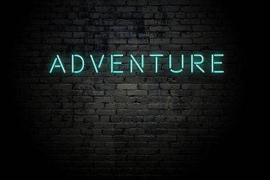 Neon yazıt macera ile vurgulu tuğla duvar