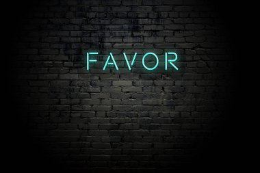 Highlighted brick wall with neon inscription favor