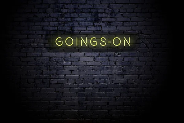 Zvýrazněná cihlová zeď s neonovým nápisem goingson — Stock fotografie