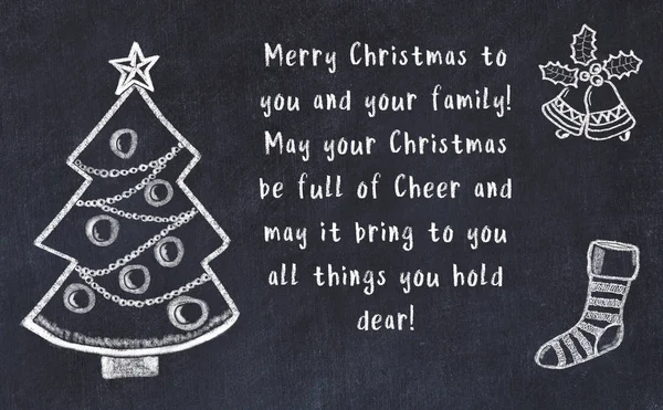 Drawing of christmas tree and handwritten greetings on black chalkboard — Stock Photo, Image