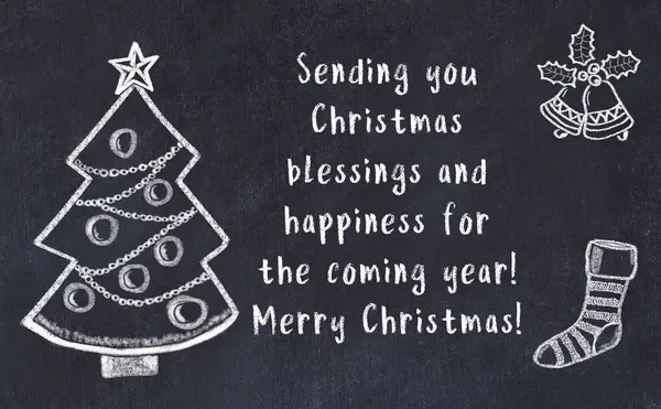 Drawing of christmas tree and handwritten greetings on black chalkboard — Stock Photo, Image