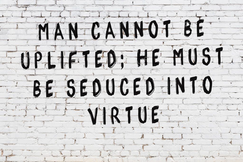 Painted black mindful inscription on white brick wall background