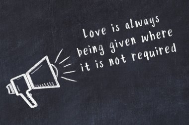 Tebeşir hoparlörü ve siyah masada akıllıca bir alıntı.