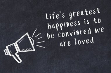 Tebeşir hoparlörü ve siyah masada akıllıca bir alıntı.