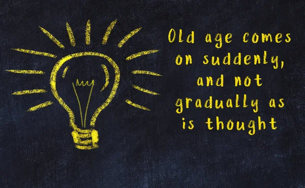 Chalk drawing of a bulb and inscription of wise quote — Stock Photo, Image