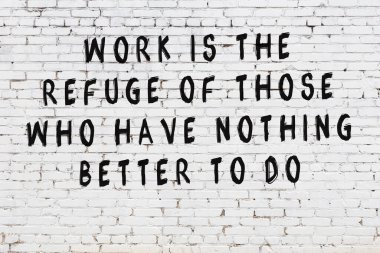 Beyaz tuğla duvar arkaplanına siyah düşünceli bir yazı.