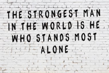 Bilgece alıntıların yazılı olduğu siyah boyanmış beyaz tuğla duvar