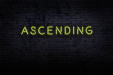Neon işareti. Kelime tuğla duvara karşı yükseliyor. Gece görünümü