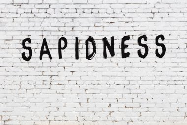 Üzerinde siyah boya yazıtları olan beyaz duvar.