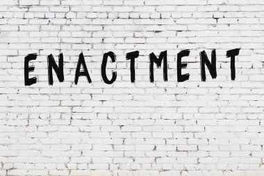 Üzerinde siyah boya harfi olan beyaz duvar.