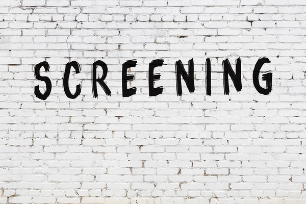 White wall with black paint inscription screening on it — Stock Photo, Image