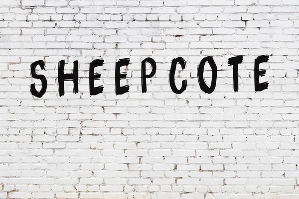 Beyaz tuğla duvara kazınmış bir yazıt.