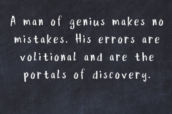 Chalk wise inscription on black chalkboard