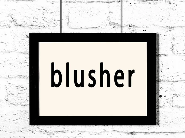 Zwart frame opknoping op witte bakstenen muur met opschrift blusher — Stockfoto