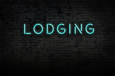 Neon işareti. Kelime tuğla duvara karşı. Gece görünümü