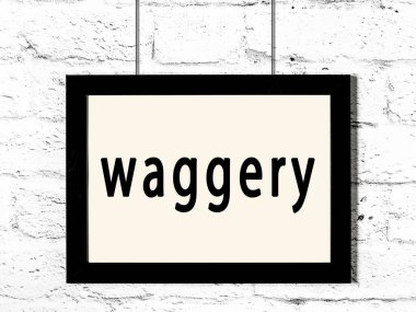 Beyaz tuğla duvarda asılı duran siyah çerçeve.