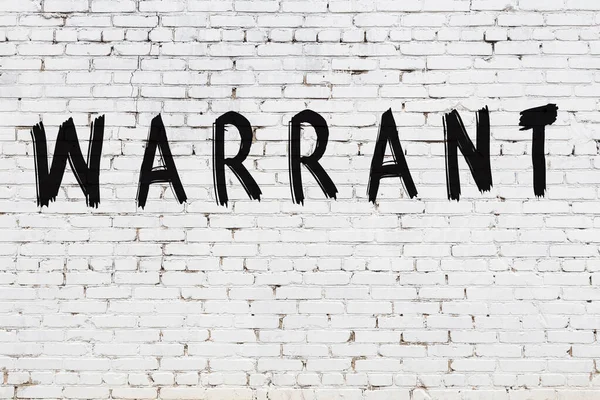 Inscription warrant painted on white brick wall — Stock Photo, Image