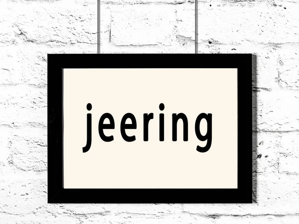 Quadro preto pendurado na parede de tijolo branco com jeering inscrição — Fotografia de Stock