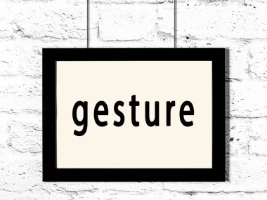 Beyaz tuğla duvarda asılı duran siyah çerçeve.