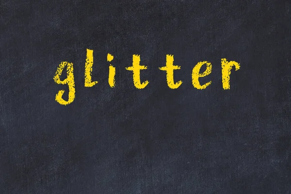 Mesa de giz da faculdade com a palavra glitter escrito em — Fotografia de Stock