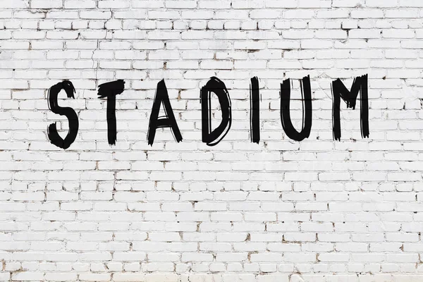 Estádio de inscrição pintado na parede de tijolo branco — Fotografia de Stock