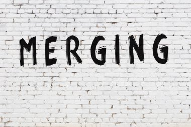 Yazı, beyaz tuğla duvara boyanmış.