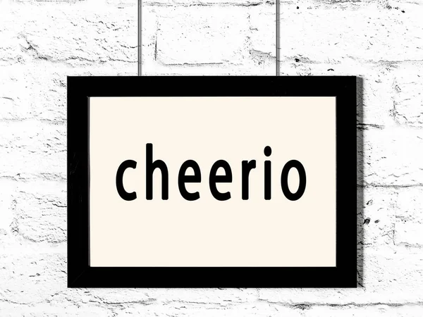 Quadro preto pendurado na parede de tijolo branco com inscrição cheerio — Fotografia de Stock