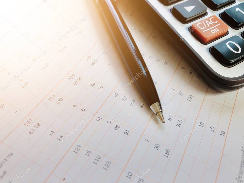 Business,finance, taxes, accounting, investment or money planning concepts : Calculator and pen on financial statements