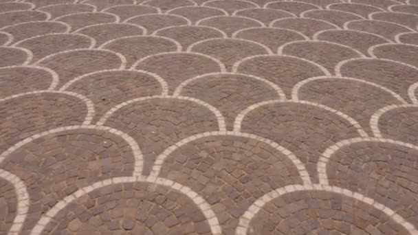 Cobbled square paved with red stone for pedestrians. Paving stone texture. Track shot top to down view. — Stock Footage Cobbled square paved with red stone for pedestrians. Paving stone texture. Track shot top to down view. Royalty Free Stock Video