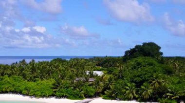 Mavi okyanus ve beyaz kum arka planında cennet gibi bir sahil tatili.