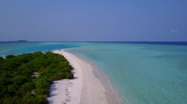 Beyaz kumlu arka planlı, berrak okyanus kıyısındaki lüks sahil yaban hayatının insansız hava aracı.