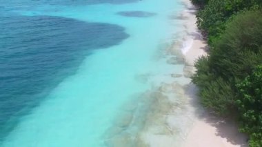 Mavi yeşil deniz ve beyaz kumlu arka planda tropikal deniz manzaralı plaj tatilinin insansız hava aracı görüntüsü