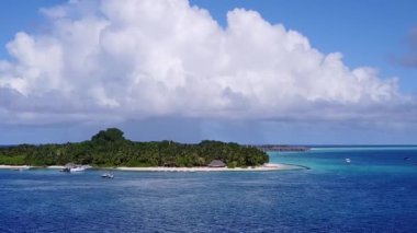 İHA turizmi. Beyaz kum arka planlı mavi deniz kenarında cennet gibi bir sahil yaşam tarzı.