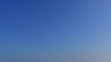 Mavi göl kıyısındaki turistik plaj tatili ve kumsalın yakınındaki beyaz kumsal manzarası.