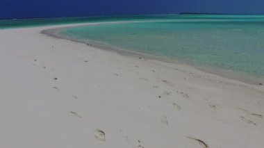 Açık deniz kıyısındaki tropikal sahil yolculuğunun sıcak dokusu ve dalgalara yakın beyaz kumlu arka plan