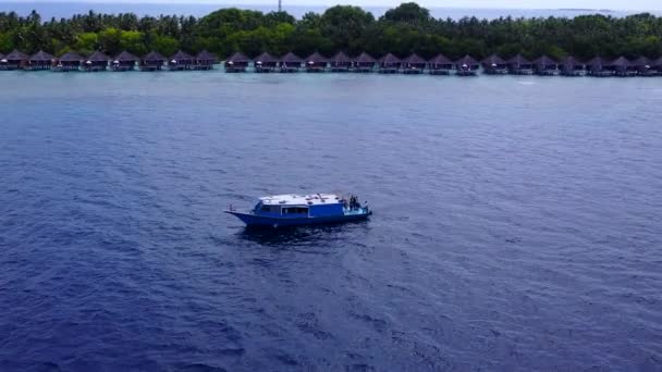 日の出後に白い砂浜を背景に青い水で熱帯の海岸線の休暇の性質を閉じます — ストック動画