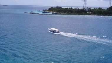 Lüks turistik plaj manzarasını kapatın. Sığ deniz kıyısında, kumsalın kenarındaki parlak kumlu arka planda.