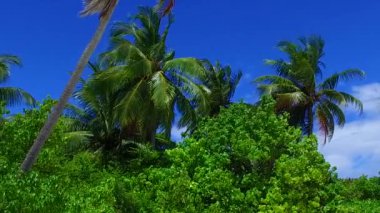 Cennet tatil beldesi sahil gezisinin mavi yeşil deniz ve beyaz kumlu arka plan manzarasını güneş batmadan kapatın.