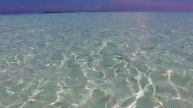 Gün batımından önce deniz mavisi gölün kenarındaki sakin turistik plaj yaban hayatının ve temiz kumlu arka planının doğası.