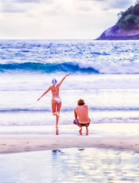 People on the beach. A man and a woman are on the beach.