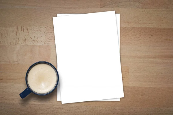 Blank letterhead and coffee cup on wooden table background. Blank branding template. Mockup for branding identity for placing your design. Top view.