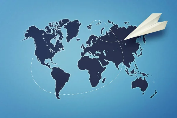 De wereld rond. Papieren vliegtuigje vliegen boven de wereldkaart. — Stockfoto